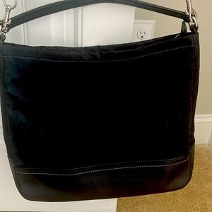 Coach Signature black bag with crossbody strap. Free gift with purchase!